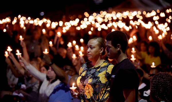 Veronica Hartfield, stands with her son, Ayzayah Hartfield during a candlelight vigil for her husband, Las Vegas police officer Charleston Hartfield, Thursday, Oct. 5, 2017, in Las Vegas. Hartfield was killed during the Sunday night shooting at the Route 91 Harvest country music festival. Gregory Bull/Associated Press