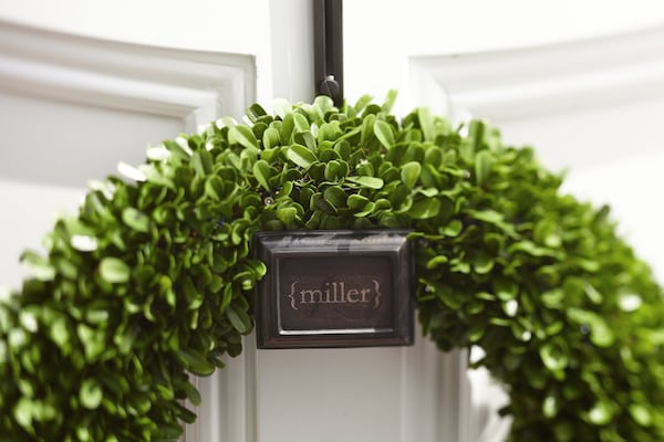 The Ella adjustable door wreath hanger features a bronze square that can be personalized. Contributed by Pottery Barn