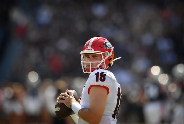 Georgia quarterback JT Daniels (18) throws during warmups before the Bulldogs faced Auburn Saturday, Oct. 9, 2021, at Jordan-Hare Stadium in Auburn, Ala. Daniels did not play in the game. (Hyosub Shin / Hyosub.Shin@ajc.com)