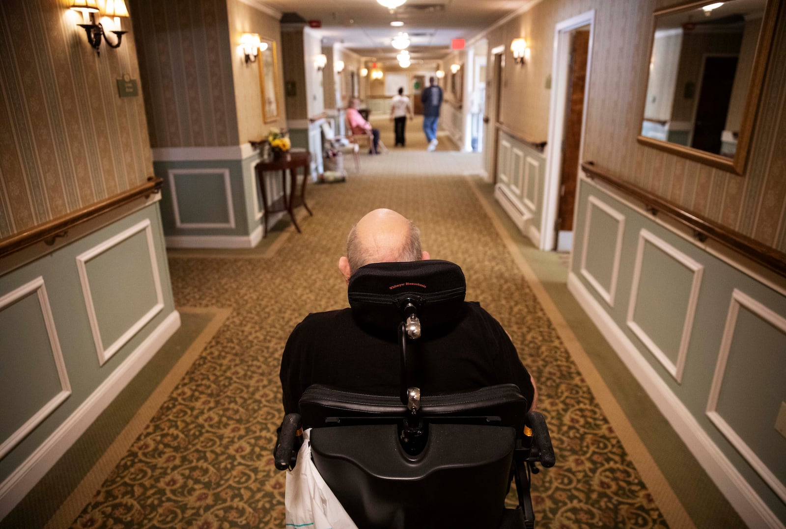 FILE - A resident makes his way to the dining room for lunch at a nursing home in Rockland, Mass., on March 6, 2020. (AP Photo/David Goldman, File)