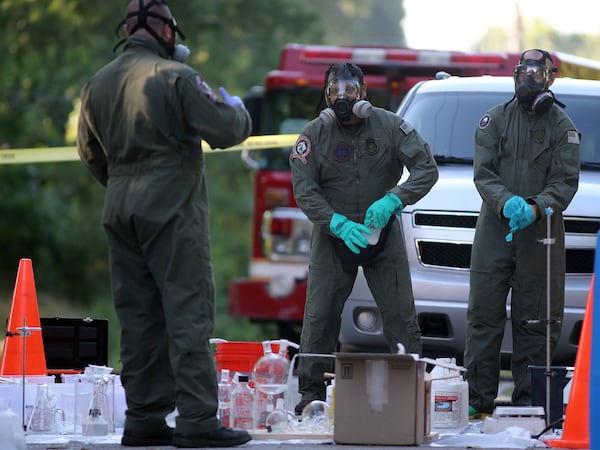 June 19, 2013 Avondale Estates: DEA agents help clean up a synthetic drug lab that was found in a house on Rockbridge Road in Avondale Estates on Wednesday afternoon June 19, 2013. BEN GRAY / BGRAY@AJC.COM