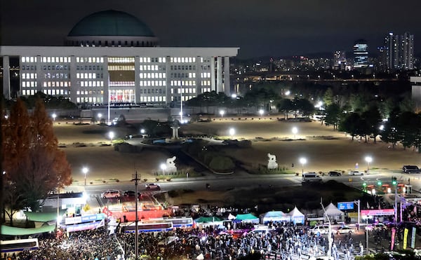 People gather to demand South Korean President Yoon Suk Yeol to step down in front of the National Assembly in Seoul, South Korea, Wednesday, Dec. 4, 2024. (Kim Do-hoon/Yonhap via AP)