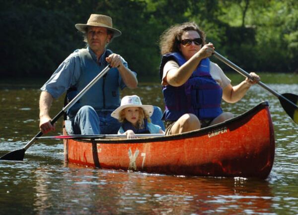 Family Canoe Day was held on at the Chattahoochee Nature Center on Saturday. The event teaches kids with their parents the ins and outs of navigating a canoe. The class culminates with a bit of canoeing in Beaver Pond. Here, Jeff and Cailin Thelen and daughter Valentina, 5, enjoy a leisurely paddle.