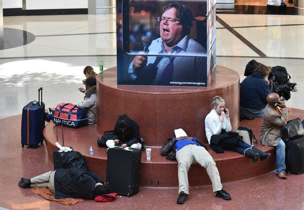 Travelers endured delays and cancellations at Hartsfield-Jackson  International Airport on Saturday, Dec. 9, 2017, in the wake of snow that came into the region starting Friday. Snow had stopped falling and started melting in many areas throughout metro Atlanta on Saturday afternoon, but that could lead to another potential hazard for many residents: Widespread black ice on the roadways is possible early Sunday as the temperature is expected to fall to the mid-20s overnight, Channel 2 Action News meteorologist Katie Walls said.  