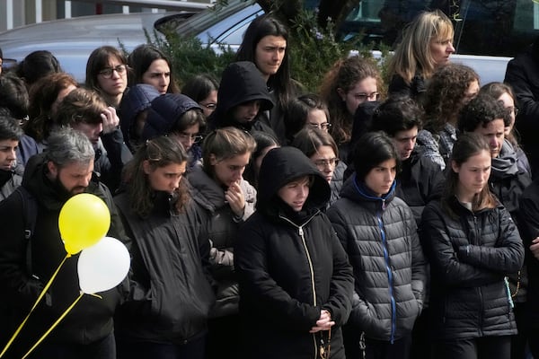 Faithful pray for Pope Francis outside the Agostino Gemelli polyclinic in Rome, Sunday, March 16, 2025. (AP Photo/Gregorio Borgia)