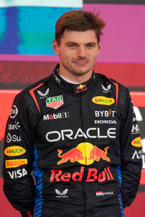 Red Bull driver Max Verstappen of the Netherlands smiles on the podium after winning the Brazilian Formula One Grand Prix at the Interlagos race track in Sao Paulo, Sunday, Nov. 3, 2024. (AP Photo/Andre Penner)