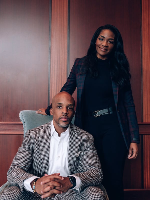 VII Group owner Chris Williams (seated) and his wife, Tiffany. Williams launched the inaugural college Holiday Hoopsgiving at State Farm Arena, played Dec. 6 and 12. (Courtesy Chris Williams)