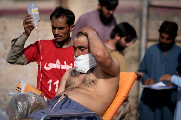 An injured passenger rescued by security forces from a passenger train attacked by insurgents arrive at a railway station in Much near Quetta, Pakistan's southwestern Balochistan province, Wednesday, March 12, 2025. (AP Photo/Anjum Naveed)