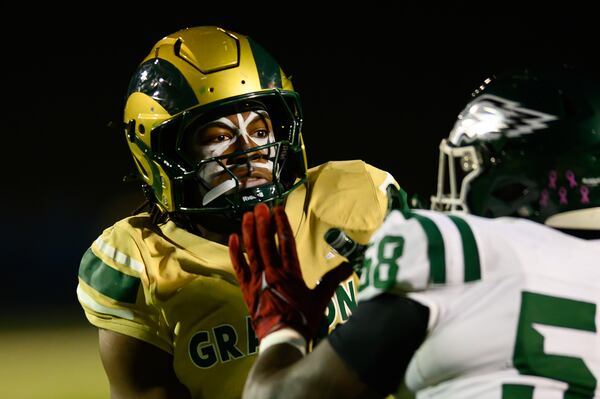 Grayson High School defensive lineman Andre Fuller makes a block during the Rams' quarterfinal win over Collins Hill.