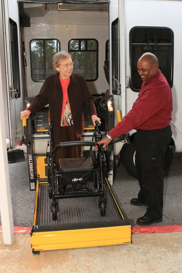 An employee with Caliber Care + Transport helps a senior from North Fulton get to her medical appointment. Senior Services North Fulton contracts with Caliber to provide door-to-door transportation for any type of health care appointment, including dental and eye appointments. The service is available to seniors 60 and older living in North Fulton. (Photo contributed by Senior Services North Fulton)