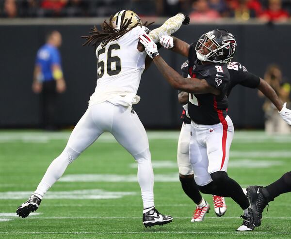 Falcons tight end Kyle Pitts throws a block for running back Cordarelle Patterson against New Orleans Saints linebacker Demario Davis in a NFL football game on Sunday, Sept. 11, 2022, in Atlanta.   “Curtis Compton / Curtis Compton@ajc.com