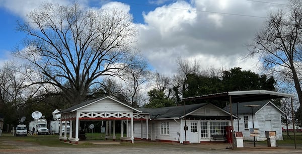 News vans and satellite trucks flank Billy Carter's famous service station.