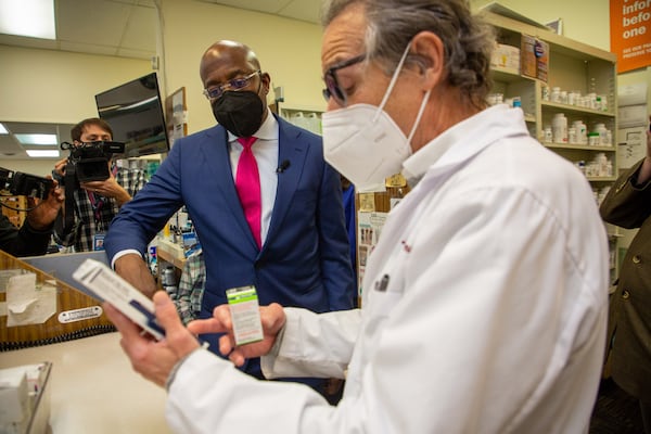 
Senator Reverend Warnock talks with Pharmacist Ira Katz about his affordable insulin act while visiting the Little Five Points Pharmacy Monday, February 28, 2022.   STEVE SCHAEFER FOR THE ATLANTA JOURNAL-CONSTITUTION