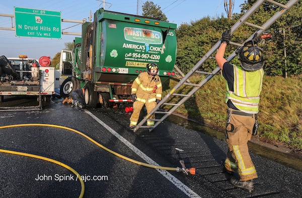 A garbage truck was involved in a crash on  I-85 at North Druid Hills early Wednesday. JOHN SPINK / JSPINK@AJC.COM