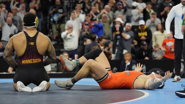 Oklahoma State's Wyatt Hendrickson, right, reacts after defeating Minnesota's Gable Steveson during a 285-pound match in the finals at the NCAA wrestling championship, Saturday, March 22, 2025, in Philadelphia. (AP Photo/Matt Rourke)