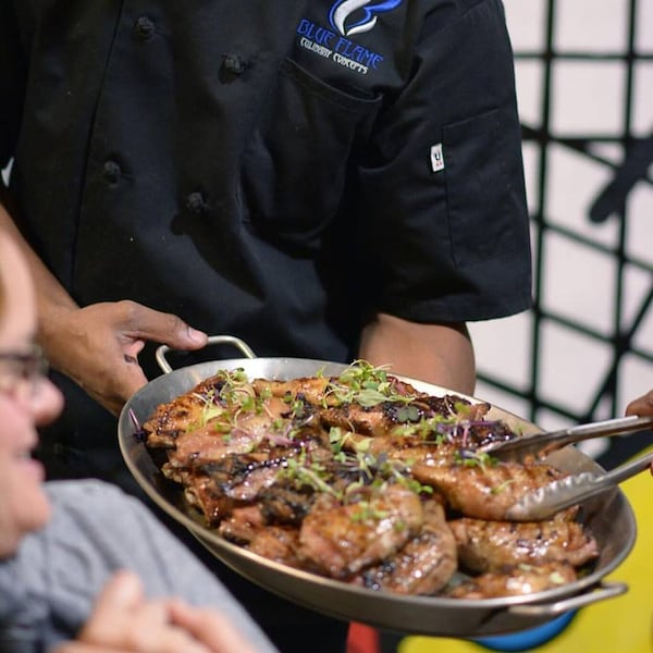 Chef Devon Banks shows off smoked organic leg quarters with truffle honey at a recent Hush Dinner Club event. CONTRIBUTED