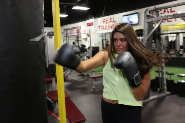 Georgia Tech student Taylor Fabacher, 22, joined martial arts and fitness gym X3 Sports in January and regularly participates in kickboxing classes. She’s also stepped into the boxing ring. TYSON A. HORNE / TYSON.HORNE@AJC.COM