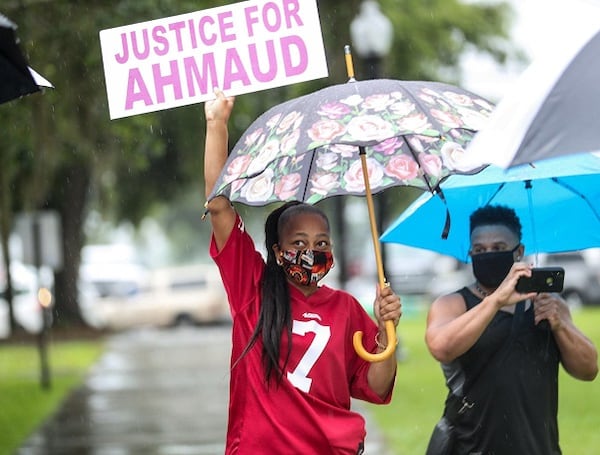 Joy Graves holds a sign outside of the Glynn County Courthouse as the preliminary preceding take place inside, Thursday, June 4, 2020. Graves says she feels anxious about the proceedings.