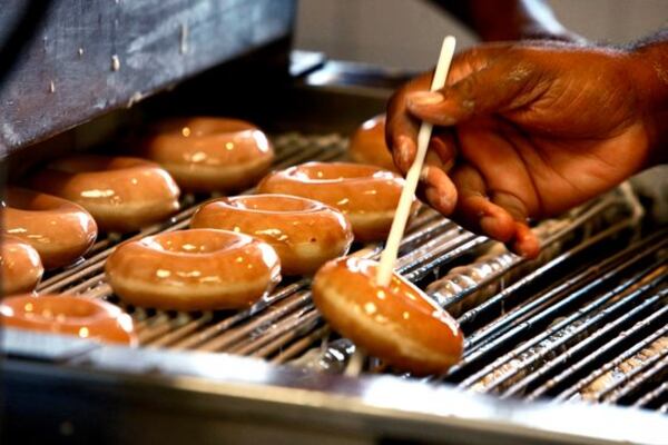 100604 - Atlanta - Doughnuts rolling off the belt - turned out to be no more than the usual on this Friday according to manager, Floyd Pope who said that with even the free doughnut offer they were not making anymore this Friday than normal. " Now if school was still in, that would be different" he said. Krispy Kreme Doughnuts at 295 Ponce de Leon was the place to be Friday, June 4, 2010 if you wanted a free doughnut. Two major doughnut chains are offering free treats to celebrate National Doughnut Day. Dunkin' Donuts will be offering customers a free doughnut with any beverage purchase at all locations. Not to be outdone, Krispy Kreme has announced that all customers will receive a free doughnut, with no purchase necessary. According to Krispy Kreme's Web site, National Doughnut Day was established in 1938 as a fundraiser for the Salvation Army and to honor women of the Salvation Army who served doughnuts to soldiers during World War I. John Spink jspink@ajc.com