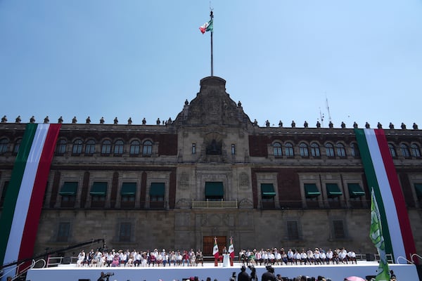 President Claudia Sheinbaum addresses supporters at a rally she convened to welcome U.S. President Donald Trump's decision to postpone tariffs on Mexican goods for one month at the Zocalo, Mexico City's main square, Sunday, March 9, 2025. (AP Photo/Eduardo Verdugo)