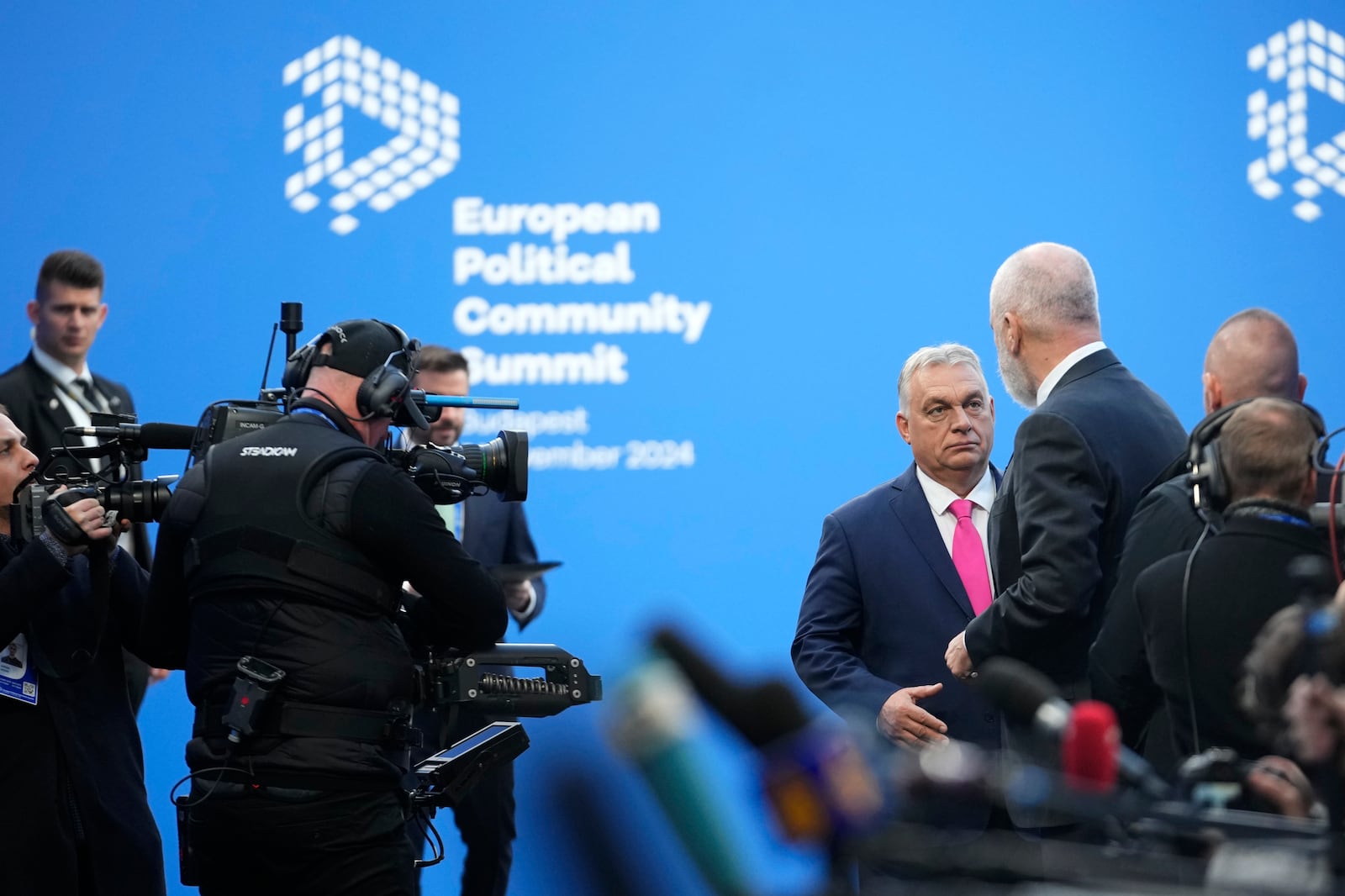 Albania's Prime Minister Edi Rama, right, speaks with Hungary's Prime Minister Viktor Orban, center, as he arrives for the European Political Community (EPC) Summit at the Puskas Arena in Budapest, Hungary, Thursday, Nov. 7, 2024. (AP Photo/Petr Josek)