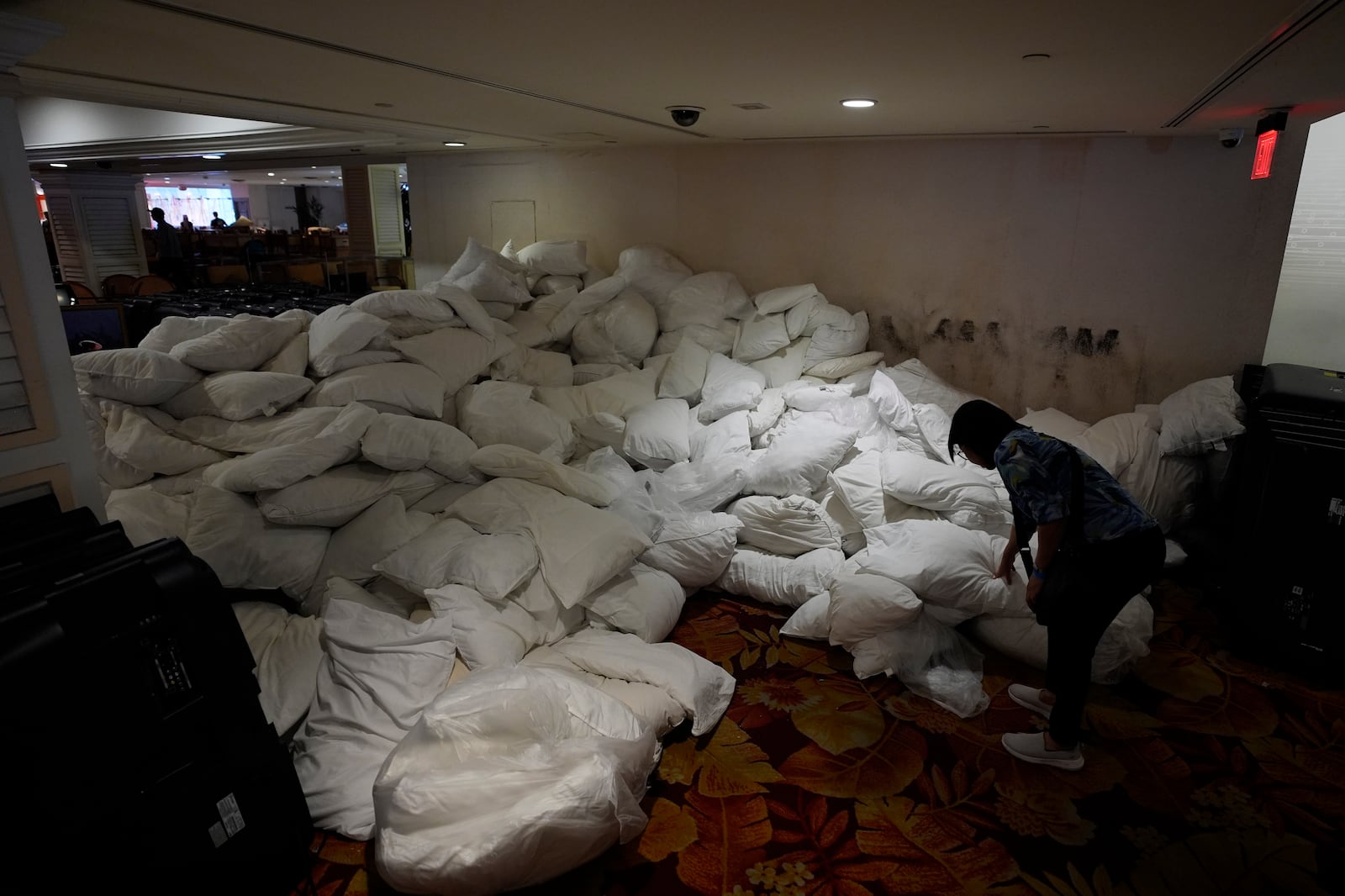 A person looks at a pile of pillows for sale at the shuttered Tropicana hotel-casino Saturday, May 25, 2024, in Las Vegas. (AP Photo/John Locher)