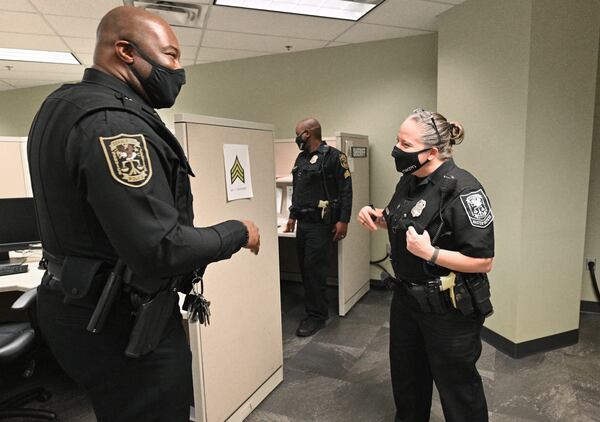 DeKalb County Officer A. Cochran (right), sharing a laugh with Lt. J.D. Sawyer, helped a deaf man Jan. 12.