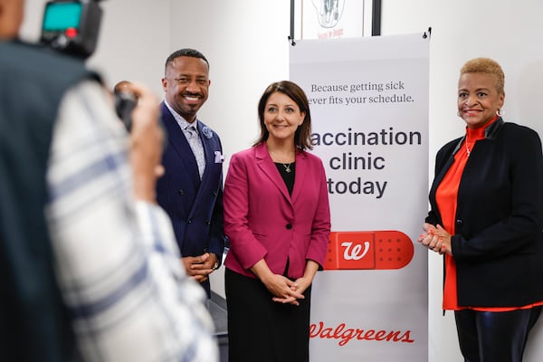 In this October file photo, (Left to right) Morris Brown College president Kevin James, CDC Director Dr. Mandy Cohen and Conference of National Black Churches president Jacqui Burton take a photo during a tour of a vaccine clinic hosted by the Conference of National Black Churches. (Natrice Miller/ Natrice.miller@ajc.com)