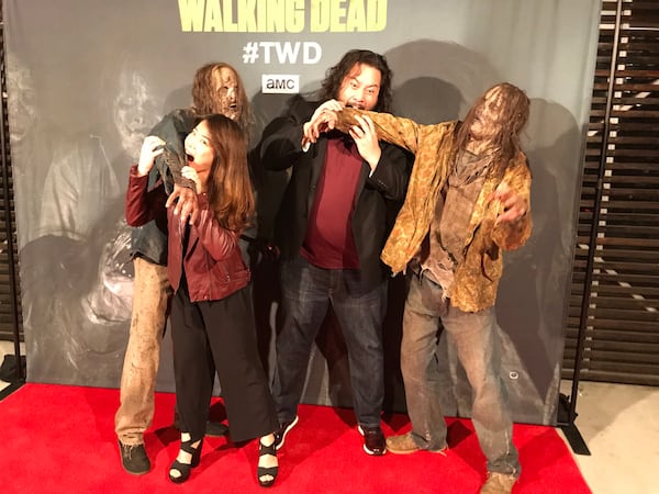 Abin Shim (L) and "Walking Dead' actor Cooper Andrews (right) turn the tables on two walkers at The Walking Dead Super Bowl party at Dallas Austin's home January 31, 2019. CREDIT: Rodney Ho/rho@ajc.com