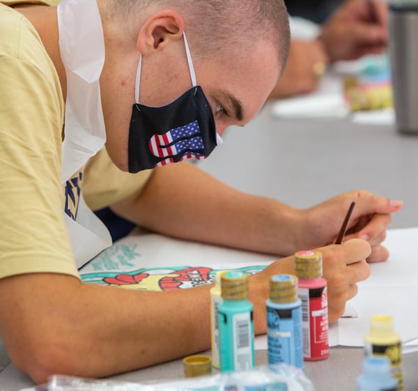 St. Pius X Catholic School football player Jimmy Brady paints a heart board to show his support and appreciation to healthcare workers during the pandemic. PHIL SKINNER FOR THE ATLANTA JOURNAL-CONSTITUTION.