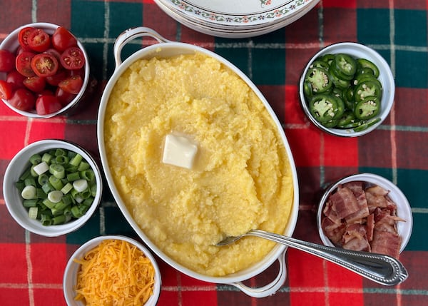 Stone ground grits cooked overnight in the slow cooker becomes a customizable grits bar when served with bacon, green onions, jalapeno, grape tomatoes and shredded cheese. 
(Virginia Willis for The Atlanta Journal-Constitution)