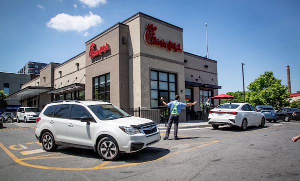 Employees direct traffic and take orders outside the Chick-fil-A on Northside Drive in Atlanta on Monday April 19, 2021. Sales for the overall Chick-fil-A chain were up last year, even with the pandemic, compared to the year before, according to company disclosure documents. STEVE SCHAEFER FOR THE ATLANTA JOURNAL-CONSTITUTION