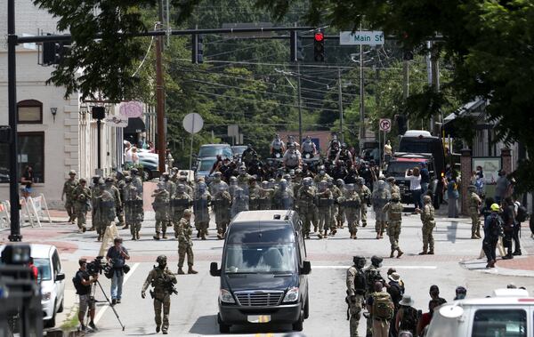 8/15/20 - Stone Mountain, GA - Police begin to move in as several far-right groups, including militias and white supremacists, rally Saturday in the town of Stone Mountain, and a broad coalition of leftist anti-racist groups organized a counter-demonstration there after local authorities closed Stone Mountain park.   Alyssa Pointer / alyssa.pointer@ajc.com