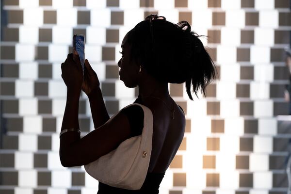 Simone Ford shoots a video at the Museum of Illusions Atlanta in Atlantic Station on Sunday, May 21, 2023.  (Ben Gray / Ben@BenGray.com)