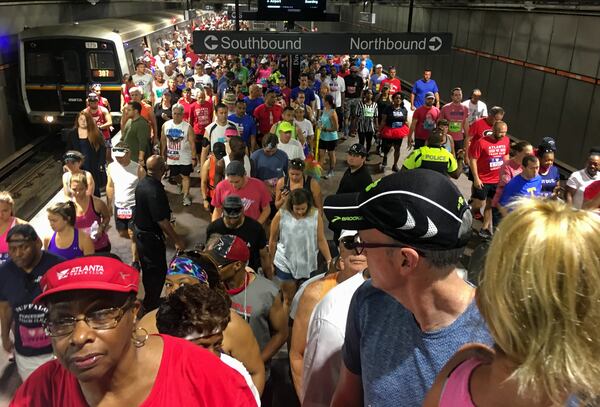 Runners crowd the Lenox MARTA station while making their way to the start of the AJC Peachtree Road Race on Wednesday morning July 4, 2018. Ben Gray / FOR THE AJC