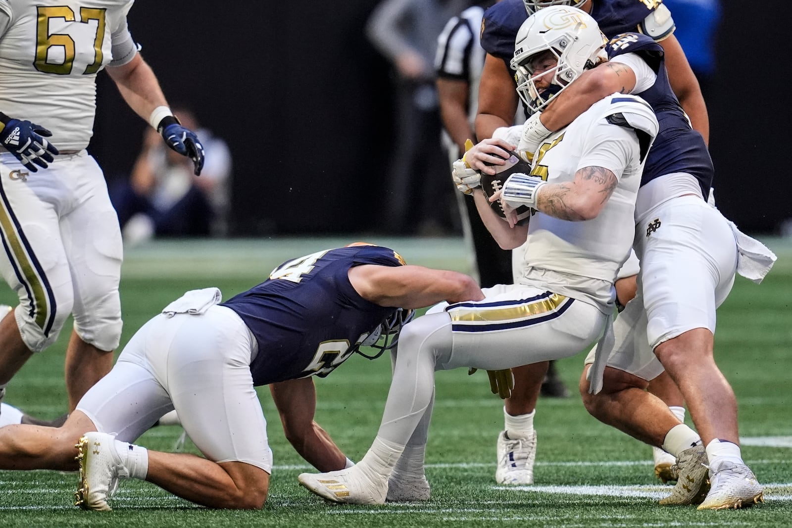 Georgia Tech quarterback Zach Pyron (5) is hit by against Notre Dames during the first half of an NCAA college football game, Saturday, Oct. 19, 2024, in Atlanta. (AP Photo/Mike Stewart)