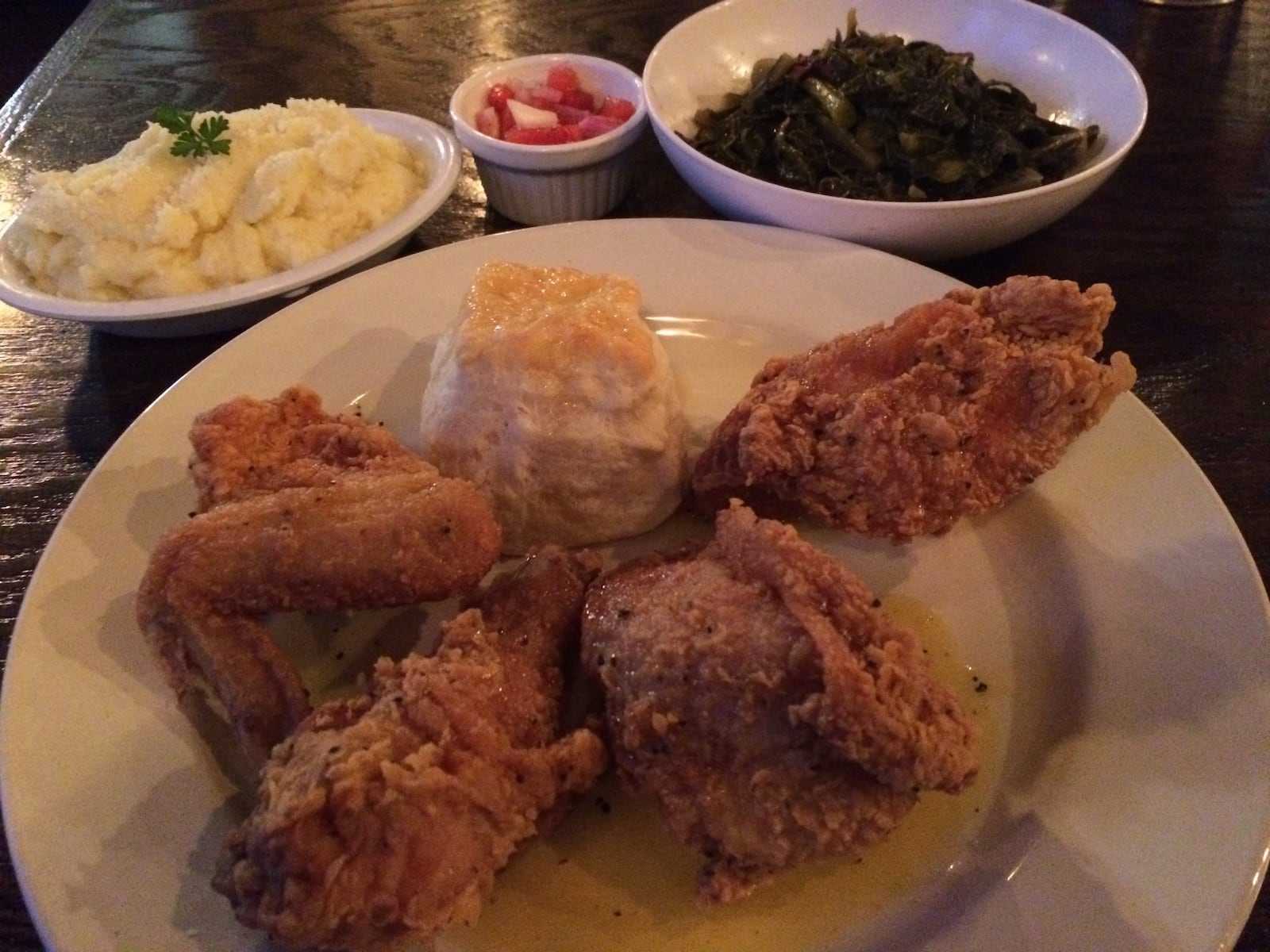 The Lemon Pepper Honey Fried Chicken at Greens & Gravy in Westview is among the best fried bird in the city. It is shown here with sides of Parmesan mashed potatoes and braised collards with smoked turkey. The greens come with a little ramekin of watermelon chowchow. CONTRIBUTED BY WENDELL BROCK