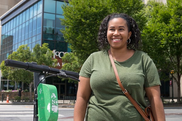 08/20/2019 -- Atlanta, Georgia -- Amber Sanchez of New York answers questions about shareable e-scooters near Centennial Olympic Park in Atlanta, Tuesday, August 20, 2019. (Alyssa Pointer/alyssa.pointer@ajc.com)