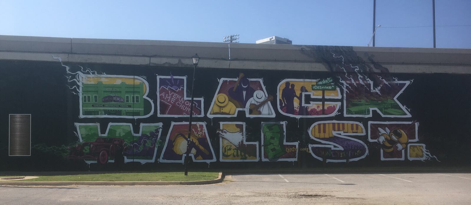 Images from Tulsa's Black Wall Street include a mural, street sign, historic sign and a photo of Vernon AME Church.