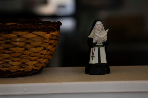 A nun figurine decorates the house of Sister Pat Murphy, 95, and Sister JoAnn Persch, 90, nuns with the Sisters of Mercy who also run a non-profit helping immigrants and asylum seekers, Thursday, Feb. 20, 2025, in Alsip, Ill. (AP Photo/Erin Hooley)