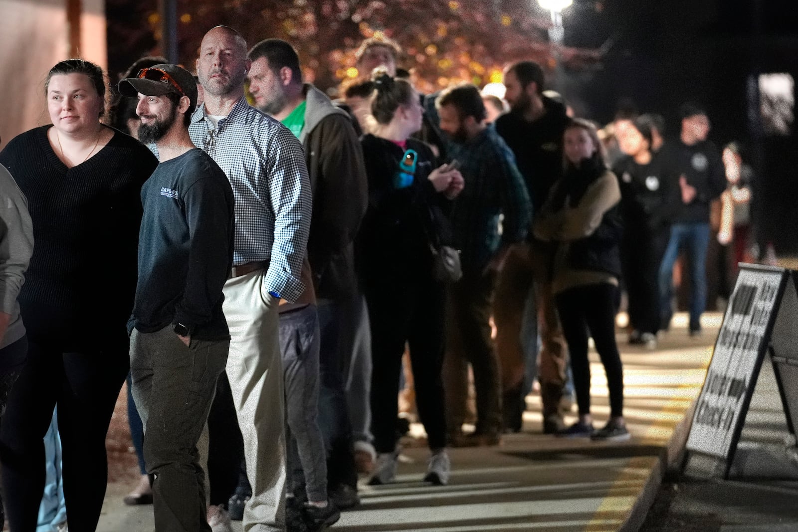 Voters stand in line to enter a polling place on the campus of Pinkerton Academy, Tuesday, Nov. 5, 2024, in Derry, N.H. (AP Photo/Steven Senne)