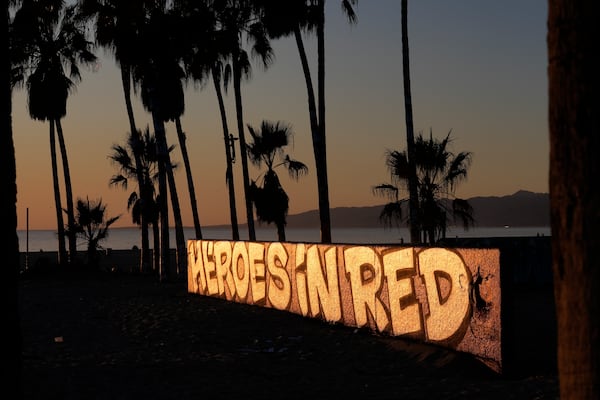 A mural by Sergei Statsenko, who also goes by the artist name Steeke, thanks firefighters in the Venice Beach area of Los Angeles as wildfires burn Monday, Jan. 13, 2025. (AP Photo/Damian Dovarganes)