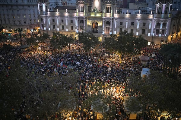 Thousands of demonstrators gather infant of the city council for a protest organized by social and civic groups, denouncing the handling of recent flooding under the slogan "MazÛn, Resign," aimed at the president of the regional government Carlos Mazon, in Valencia, Spain, Saturday, Nov. 9, 2024. (AP Photo/Emilio Morenatti)