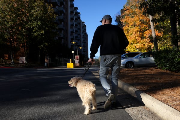 Gerard Robinson and his dog, Kerouac, return to their apartment in Atlanta after one of their daily walks on Friday, Nov. 22, 2024. (Jason Getz/AJC)
