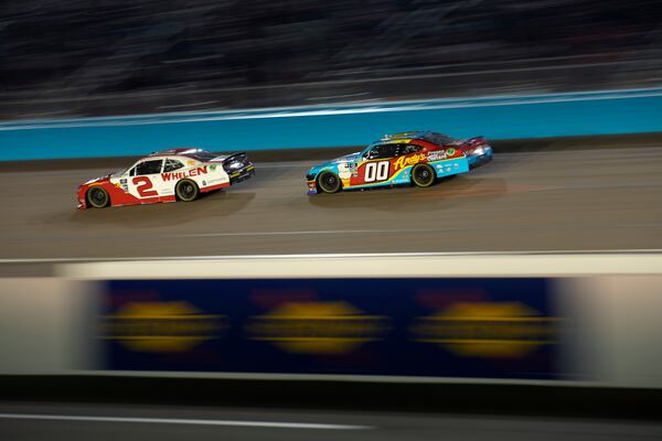 Jesse Love (2) and Cole Custer (00) drive during a NASCAR Xfinity Series auto race, Saturday, Nov. 9, 2024, in Avondale, Ariz. (AP Photo/John Locher)