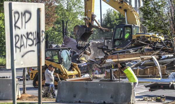 The Wendy’s where Rayshard Brooks was killed by Atlanta police last month was torn down on Tuesday, July 14, 2020. Construction crews used an excavator to demolish the charred remains of the University Avenue restaurant. It is not clear who ordered Tuesday’s demolition, which comes a little more than a week after demonstrators who had camped out at the site following Brooks’ death were forced off the property. JOHN SPINK/JSPINK@AJC.COM