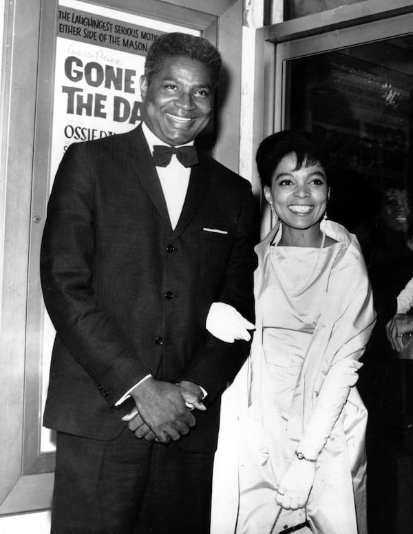 Ossie Davis  and wife, Ruby Dee pose in front of their movie poster at the opening night gala of their film "Gone Are the Days!" in New York on Sept. 23, 1963. The movie, starring the married couple, was based on Davis's play "Purlie Victorious."  (AP Photo)