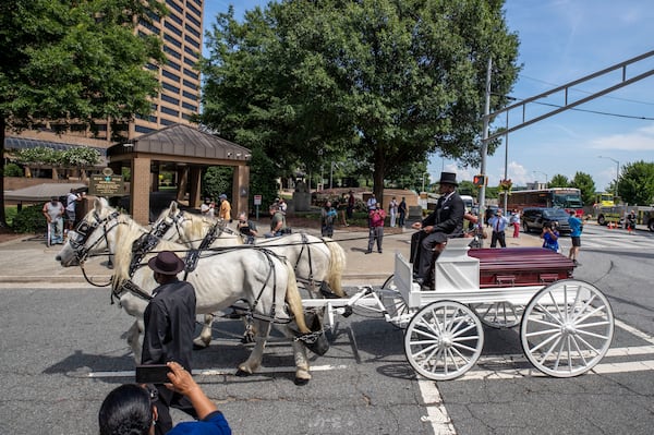 07/22/2020 - Atlanta, Georgia - A horse drawn carriage carries the body of C.T. Vivian down Capital Avenue SW toward the historic Sweet Auburn District in Atlanta, Wednesday, July 22, 2020. VivianÕs body laid in state in the rotunda of the building to celebrate his life. (ALYSSA POINTER / ALYSSA.POINTER@AJC.COM)