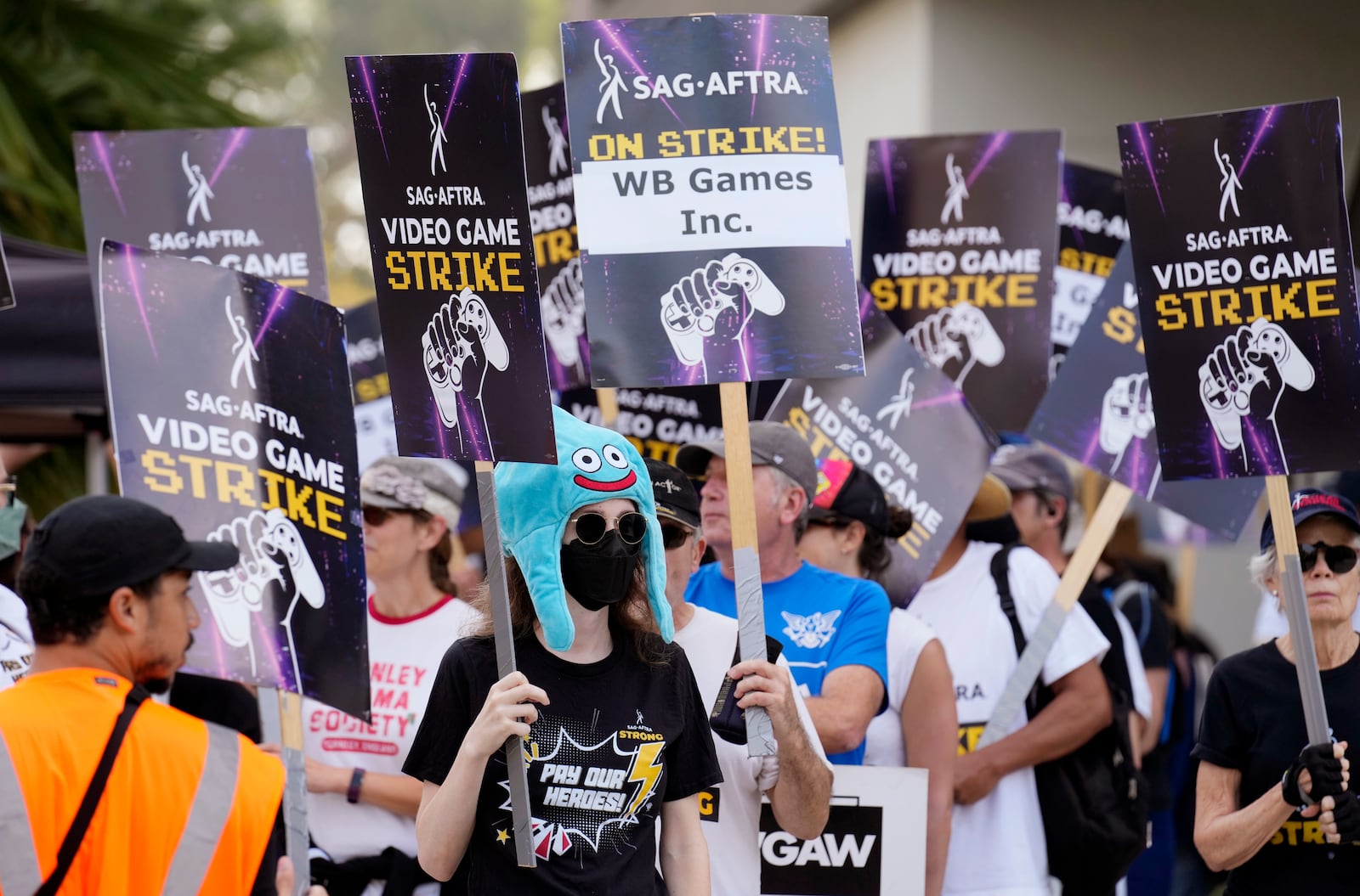 FILE - Actor Sena Bryer, second from left, joins other demonstrators in a SAG-AFTRA video game actor strike picket line outside Warner Bros. Studios on Aug. 28, 2024, in Burbank, Calif. (AP Photo/Chris Pizzello)