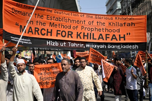 Members and supporters of the banned Islamist group Hizbut Tahrir march near Baitul Mokarram Mosque in Dhaka, Bangladesh, Friday, March 7, 2025. (AP Photo/Mahmud Hossain Opu)